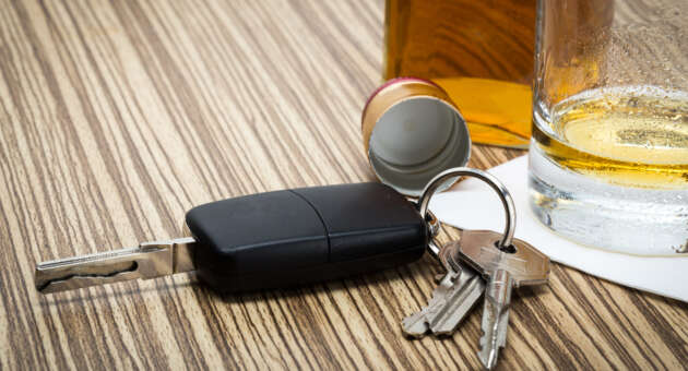 Can You Get a DUI When Not Driving in Pensacola? 1 Man in suit smirks, holding "Expunged DUI" document near Pensacola sign.