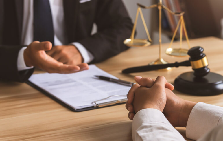 Public defender consults client, weighing private attorney option